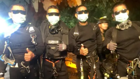 Facebook/Thai Navy Seals The last of the rescuers - one doctor and three divers, all part of the Thai Navy Seals - give thumbs up after leaving the cave system