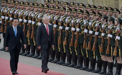 Getty Images China's Premier Li Keqiang escorts Malcolm Turnbull past a line of Chinese military guards at an official welcome ceremony in Beijing in 2016