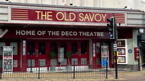 Ollie Conopo/BBC Art deco theatre frontage with "The Old Savoy" sign