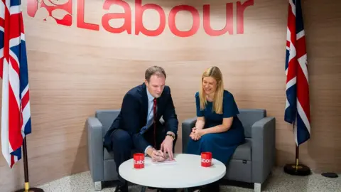 Labour Party Dan Poulter signs his Labour membership form after defecting from the Conservative party