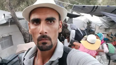 Talibshah Hosseini A selfie of Talibshah Hosseini beside his new bigger tent in Moria