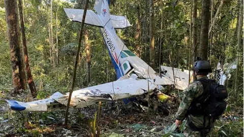Reuters A soldier stands next to the wreckage of the plane during a search for the children on 19 May