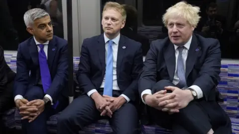 PA Media Mayor of London Sadiq Khan, Transport Secretary Grant Shapps and Prime Minister Boris Johnson