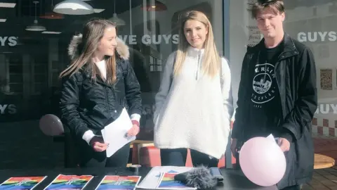 Twitter Brittany Pettibone (left), Lauren Southern (middle) and British activist Caolan Robertson (right), at a stall in Luton town centre