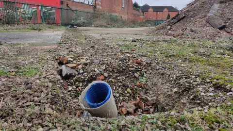 A trench and drainage pipe on the site at Phoenix Street