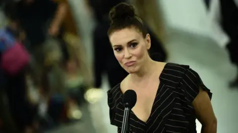 AFP/Getty Alyssa Milano addressing reporters