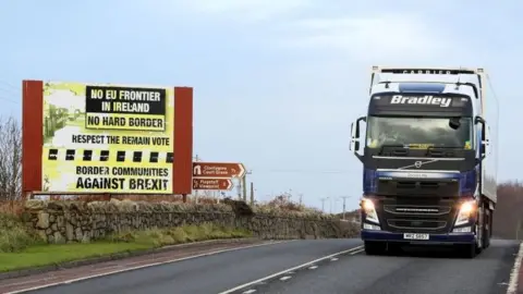 AFP Traffic passing a Brexit Border poster on the Dublin road Co Armagh border