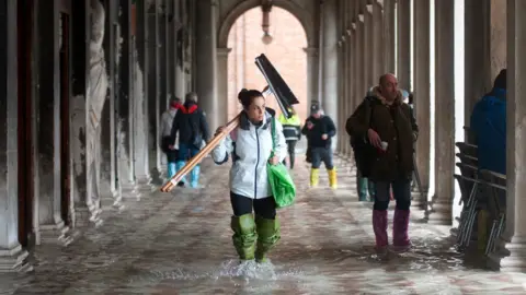 Getty Images St Mark's Square in Venice is flooded in water during an exceptional high tide, 13 November 2019