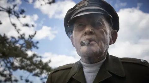 Getty Images World War Two veteran Dennis Thompson enjoys a cigar in his original uniform