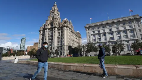 PA Media Man in mask in Liverpool