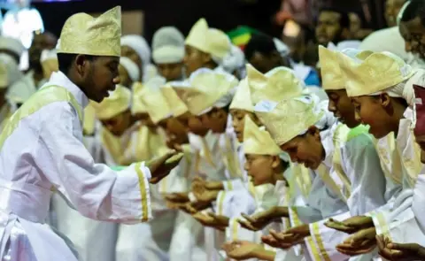Getty Images Tens of thousands of Ethiopian Orthodox believers gather at Millennium Hall in Addis Ababa, on August 4, 2018