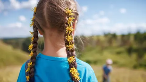 Getty Images Girl in Ukraine with flowers in her braided hair