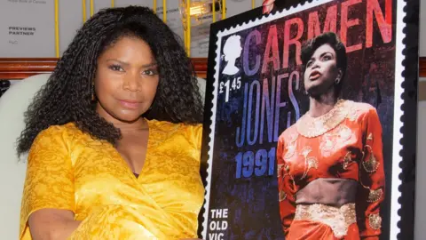 Royal Mail Sharon Benson holding her stamp