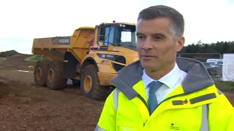 MP Mark Harper wearing a high vis jacket