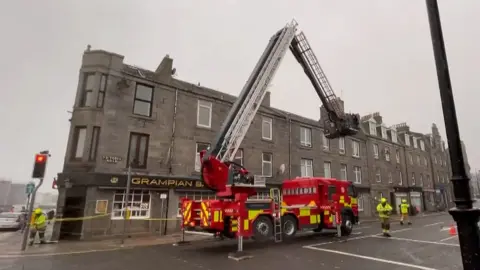 fire truck by damaged building