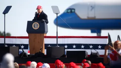 Getty Images Mr Trump addressed a re-scheduled campaign rally in Fayetteville Regional Airport, North Carolina