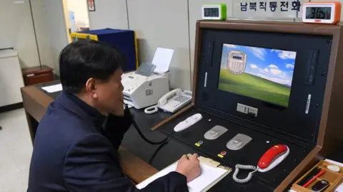 Reuters A South Korean official checks the hotline to North Korea at Panmunjom