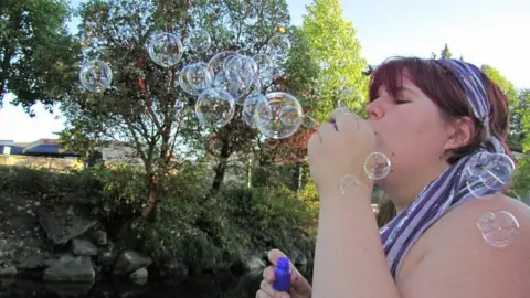 Kam Abbott Katje blowing bubbles