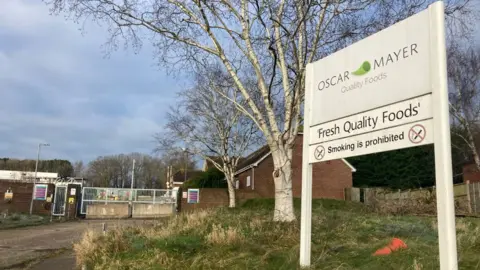 BBC Picture of factory with gates closed and sign saying Oscar Mayer