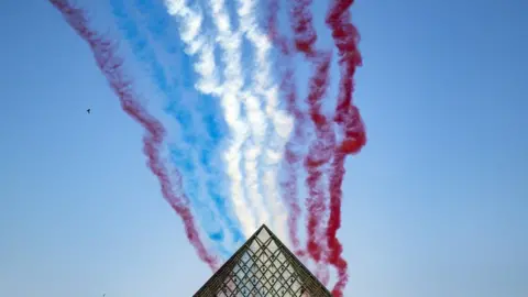 EPA Alpha Jets fly over the Louvre