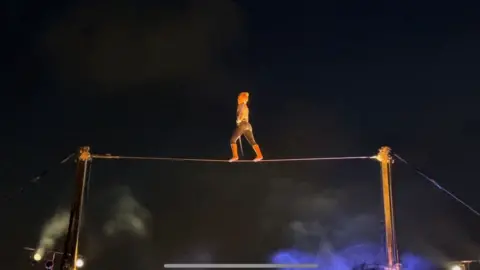 Andrew Turner/BBC Trapeze act on wire