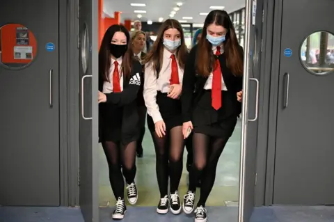 Getty Images Anyone who wishes to wear a face covering in school or on school transport is allowed - but they are not compulsory