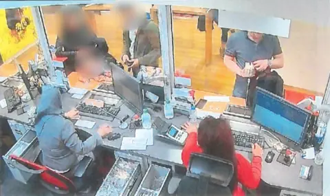 NCA Deivis Grochiatskij captured on CCTV depositing the fraudulent money at a London bank