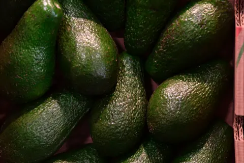 TOBIAS SCHWARZ Avocados at market