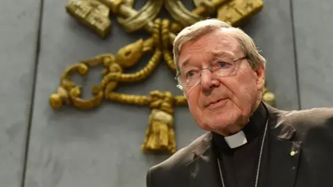 Getty Images Australian Cardinal George Pell looks on as he makes a statement at the Holy See Press Office, Vatican city