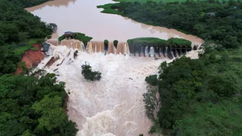 Reuters Water flows at the Carioca dam, after pouring rains in Para de Minas, in Minas Gerais state