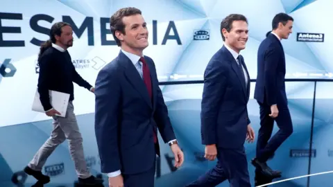 Reuters Four of the candidates - notably missing Vox's Santiago Abascal - take their places at the televised debate on the Tuesday before polling day