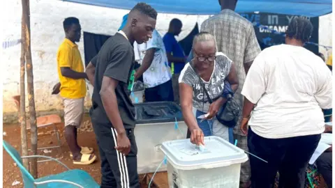 BBC Woman voting in Sierra Leone