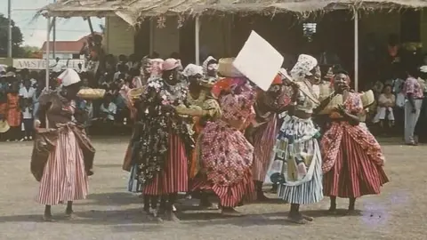 Courtesy Museum of Antigua & Barbuda Women wearing plantation-era dresses attend the 1967 Carnival