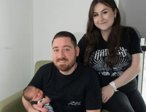 NHS New parents with their baby