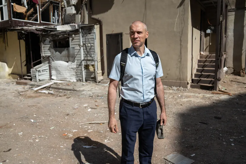 BBC Denis Masliy, of the regional prosecutor's office, in the courtyard of a building damaged by a missile strike