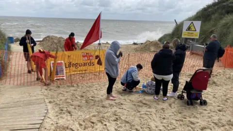 Jenny Kirk/BBC The cordon at Hemsby beach after more of the dunes were lost to the sea