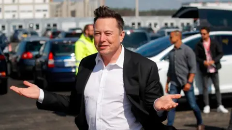 Getty Images Elon Musk with palms outstretched