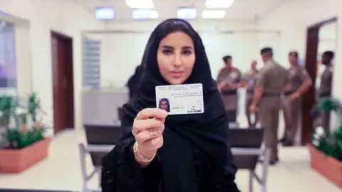 EVN A woman shows her Saudi driving license