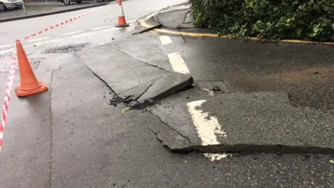 Flooding in New Quay, Ceredigion, caused damage to the road