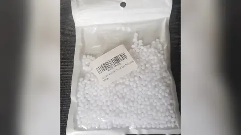 Emma Clarke Tiny plastic beads used to shape into dentures