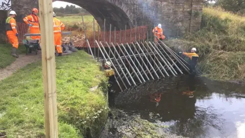 Dam being installed in canal