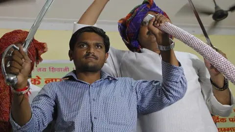 Getty Images Hardik Patel, Convener of Patidar Anamat Andolan Samiti (PAAS) being felicitated by Gurjar Community at Kotla Village, Gurjar Bhawan near Patparganj, on August 30, 2015 in New Delhi, India. Patel announced that he won't allow any political party to join his agitation and he wants to turn the stir into a national movement.
