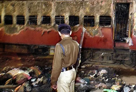 Getty Images The riots began after a fire on a passenger train in Godhra town killed 60 Hindu pilgrims