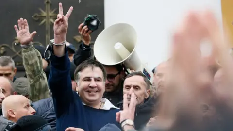 Reuters Georgian former President Mikheil Saakashvili flashes a victory sign after he was freed by his supporters in Kiev
