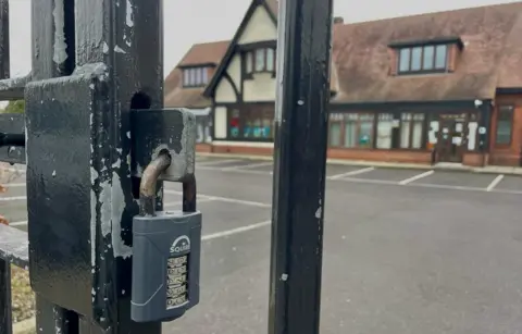 Stephen Huntley/BBC Padlocked gate at the Treehouse Nursery in Ipswich