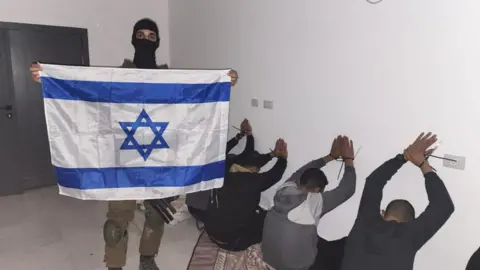 Facebook Israeli soldier posts photo of detainees while holding an Israeli flag
