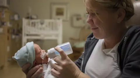 Getty Images Mother feeding premature baby