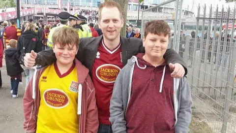 Dunn Family Harry and twin brother Niall with older brother, Miles, at Wembley in 2013