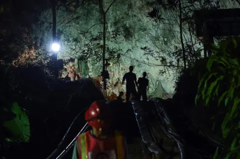 AFP Thai soldiers stand at the mouth of Tham Luang cave