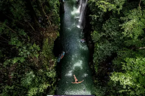 Dean Treml/Red Bull/Getty Images Eleanor Smart of the USA dives from the 21 metre platform during the final competition day of the fourth stop of the Red Bull Cliff Diving World Series on August 03, 2023 at Takachiho, Japan.
